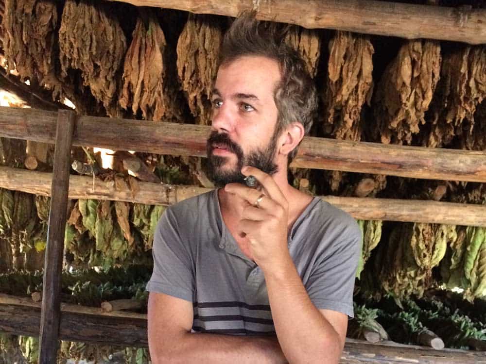 Alexandre with cigar in a Viñales tobacco barn