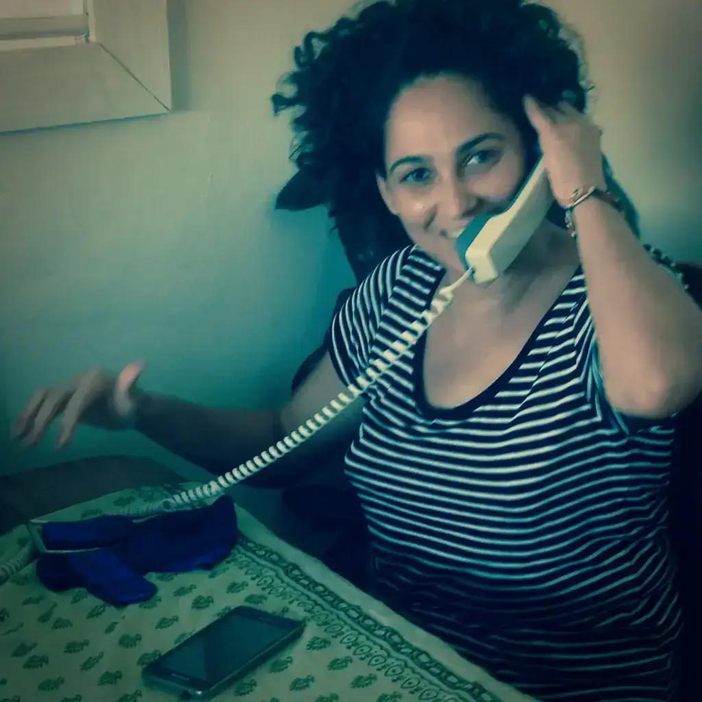 Ida contestando al teléfono de asistencia con alegría y sonrisa